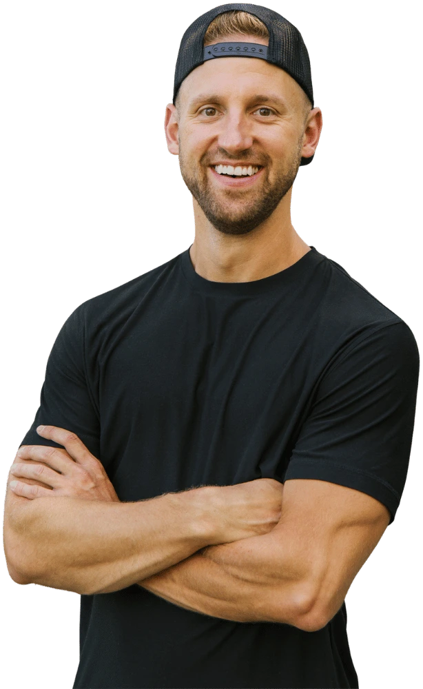 Jake Pfohl smiling with arms crossed, wearing a black t-shirt and hat, personal branding photo